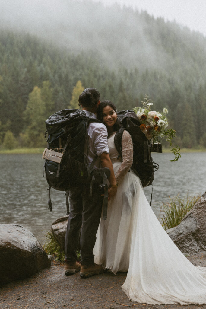 bridge and groom hike to alpine lake for hiking elopement
