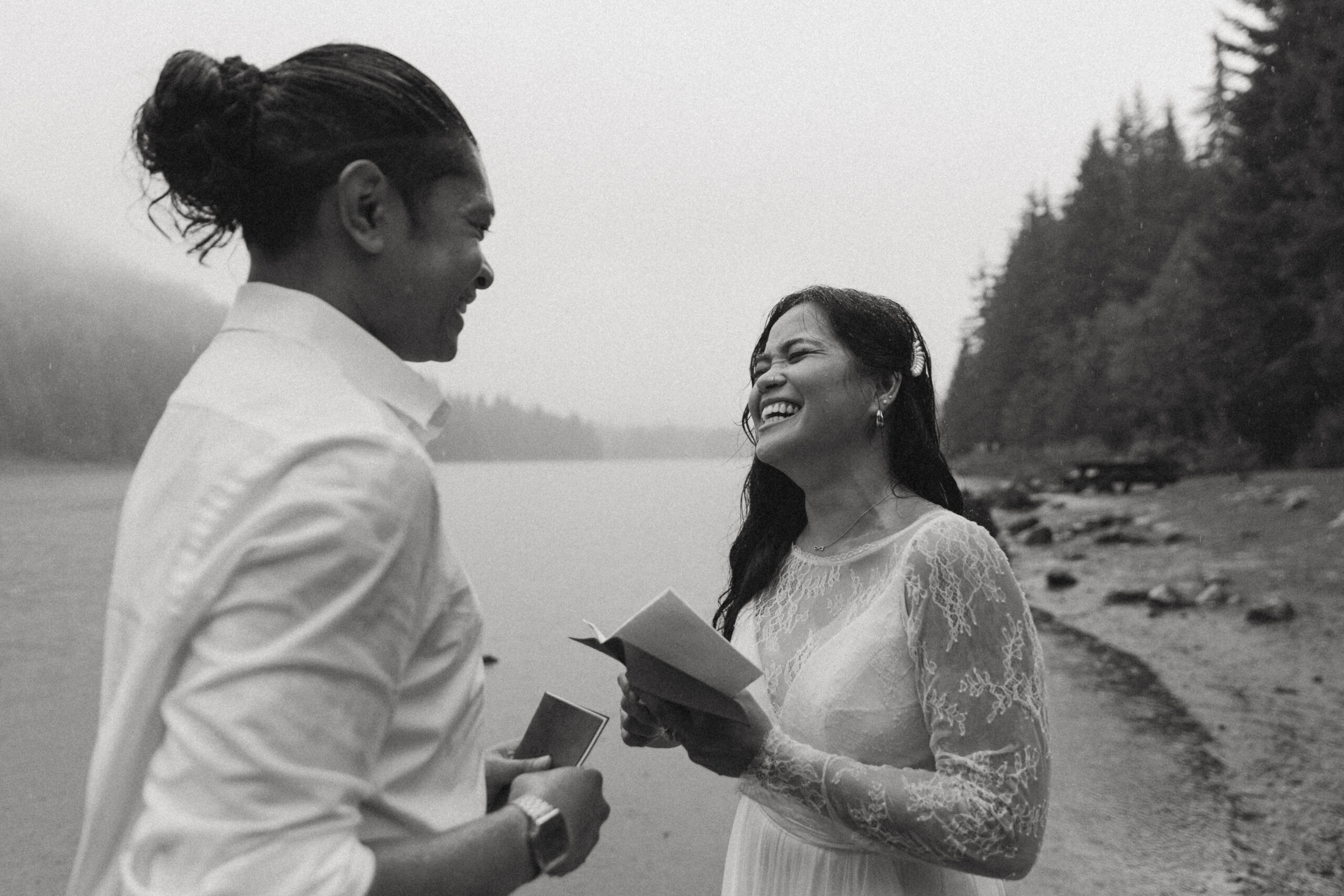 bridge and groom read intimate vows beside a lake