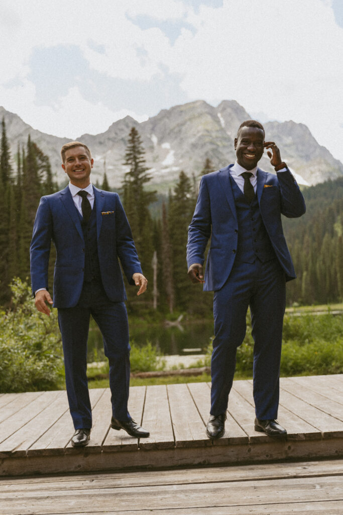 Two men share a moment standing at the alter overlooking Island Lake