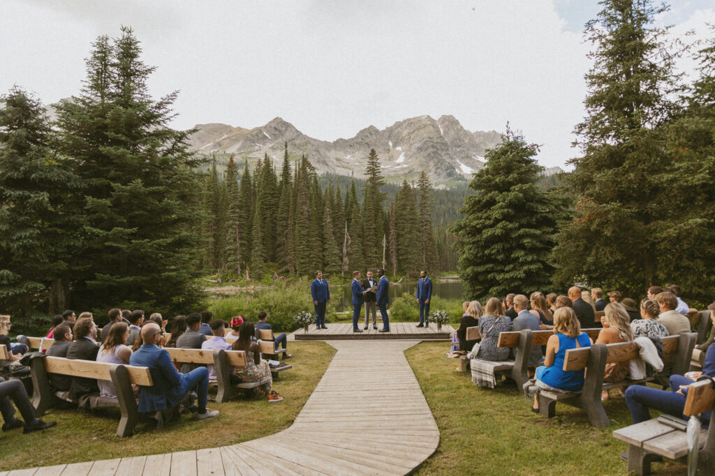 Couple stands at the alter while saying their vows overlooking Island Lake