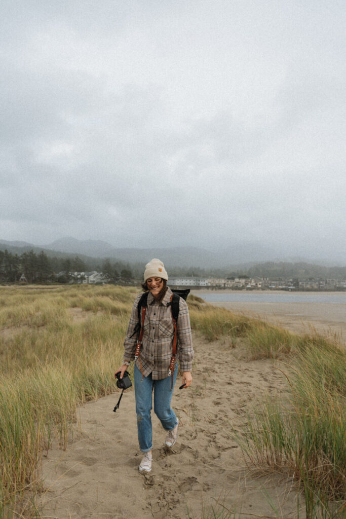 A smiley and happy Alberta elopement photographer with beachy view in the backdrop