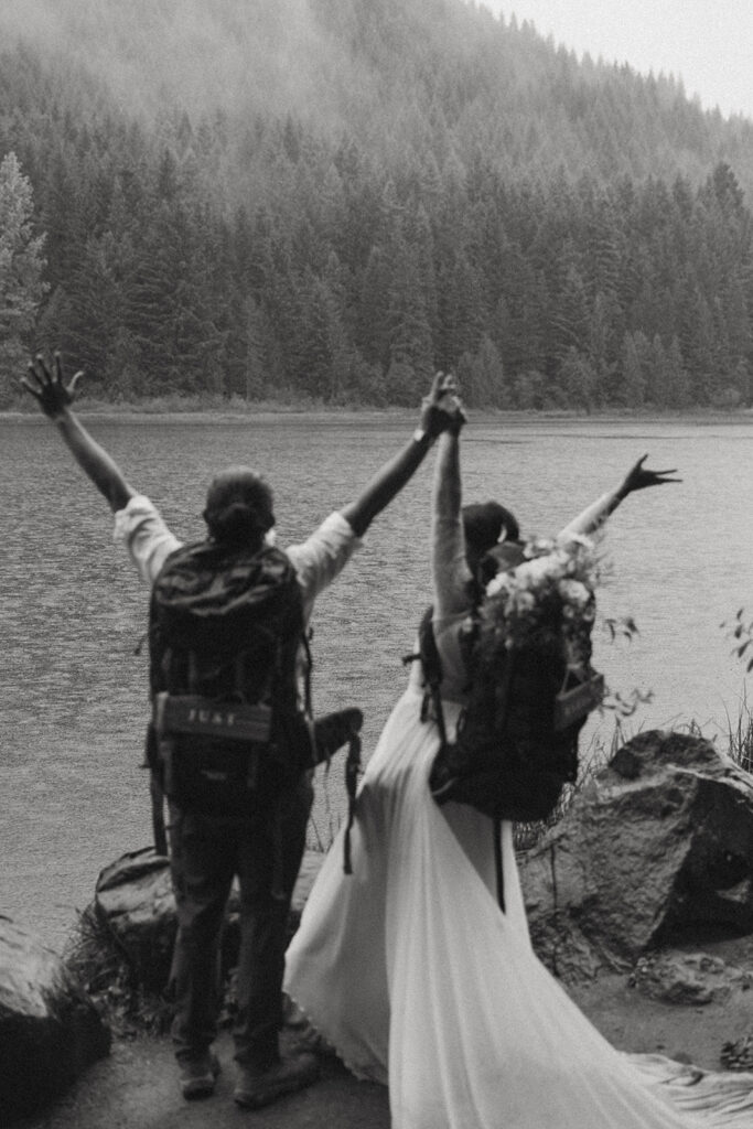 adventurous bride and groom with backpacks going hiking for their banff elopement 