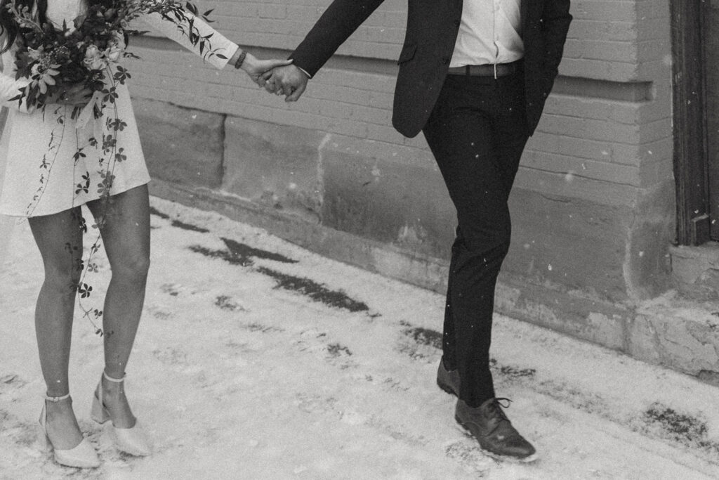 close up of couples legs as they are walking during a winter elopement