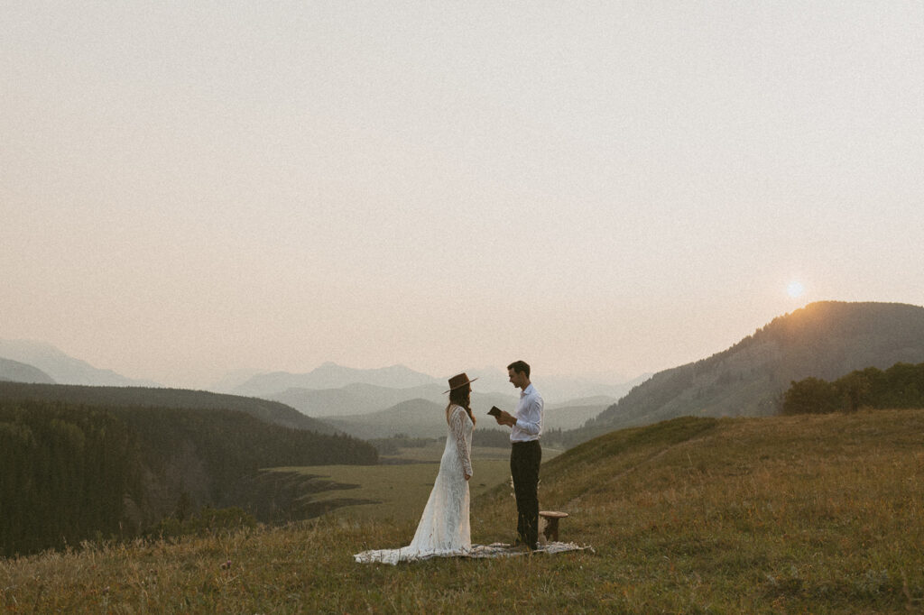 bride and groom exchanging vows in a field