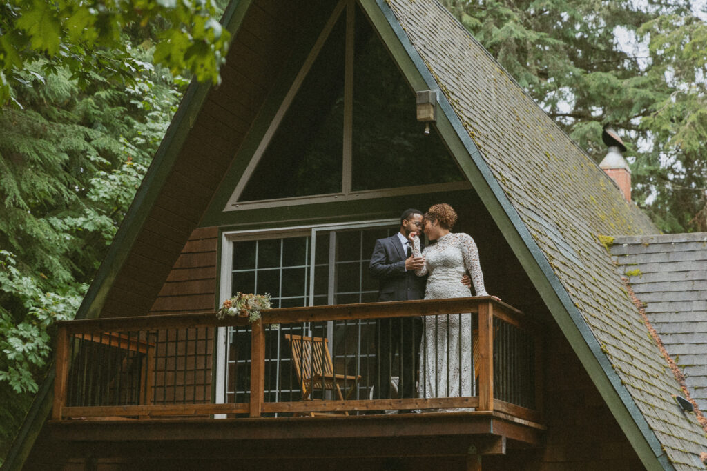 bride and groom on a balcony during their airbnb elopement