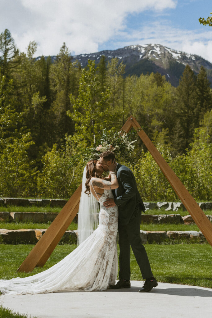 bride and groom first kiss at their fernie wedding