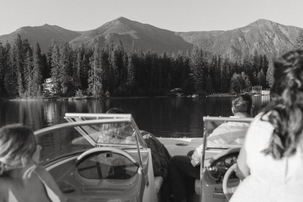 bride and groom riding boat at rosen lake near cranbrook.