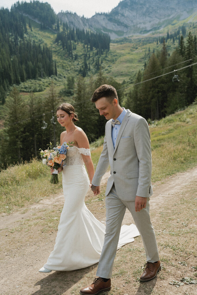 Bride and groom embracing with mountain views at Fernie Alpine Resort