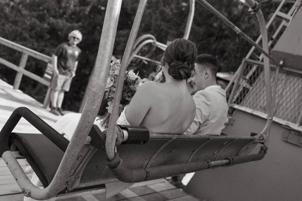 bride and groom on ski lift at their Fernie Alpine Resort wedding