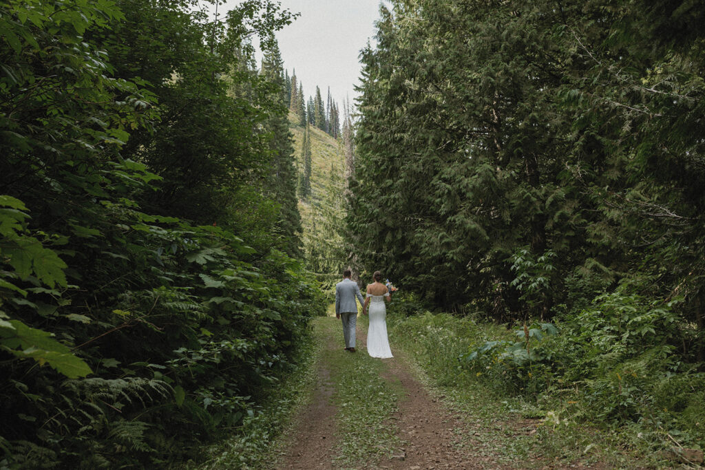 Couple walking hand-in-hand at Fernie Alpine Resort wedding