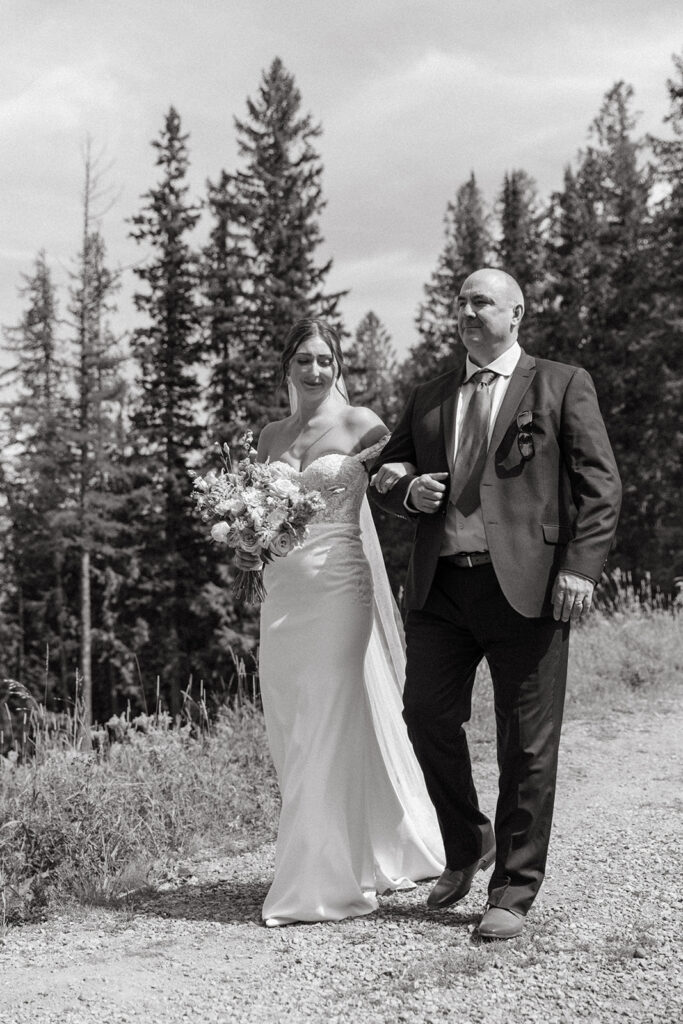 bride walking down aisle at Fernie Alpine Resort wedding