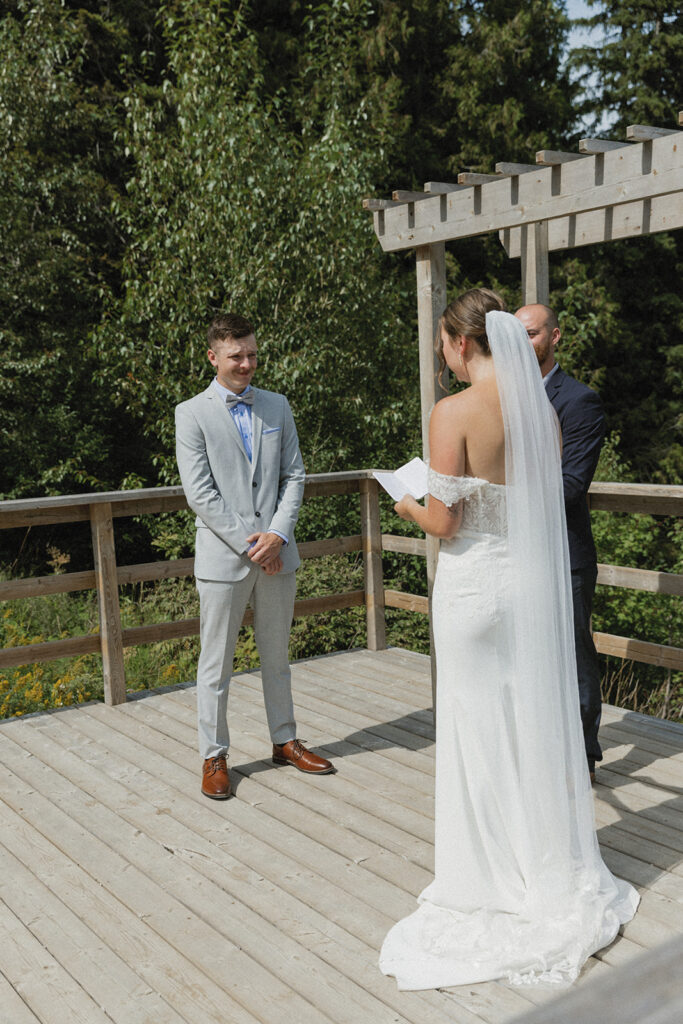 bride and groom exchaning vows at Fernie Alpine Resort wedding