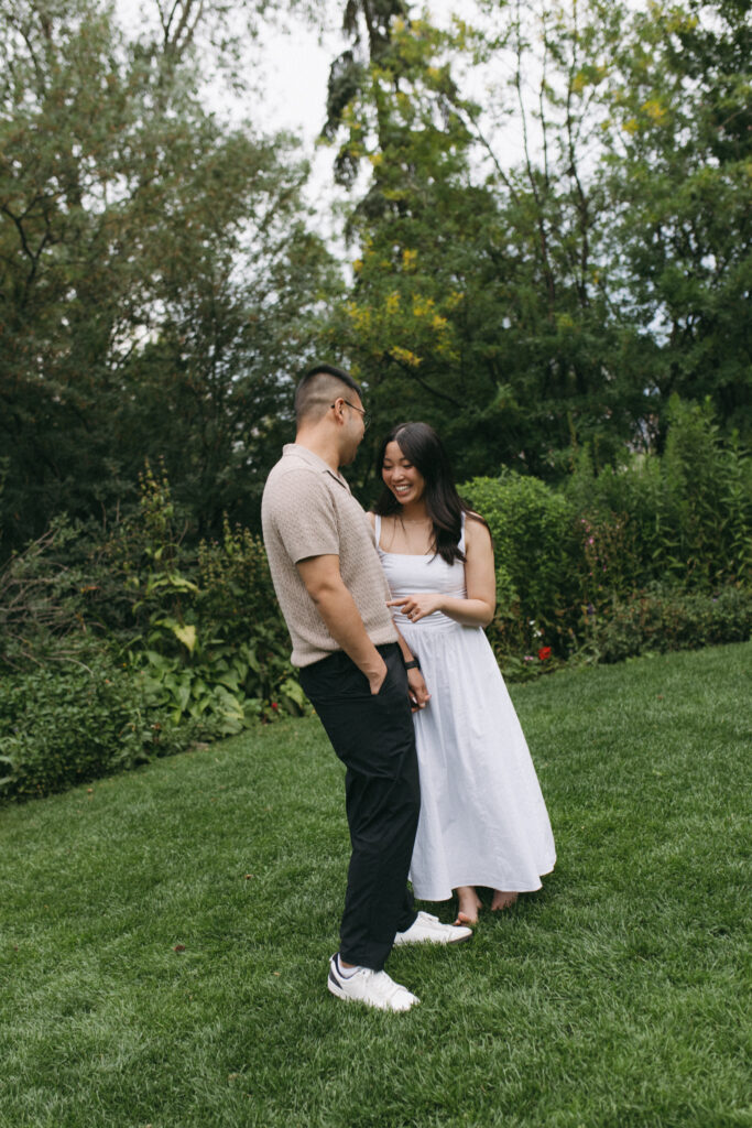 Lisa and Peter laughing together during their Calgary engagement session at Reader Rock Garden, genuine connection captured by Alberta wedding photographer.