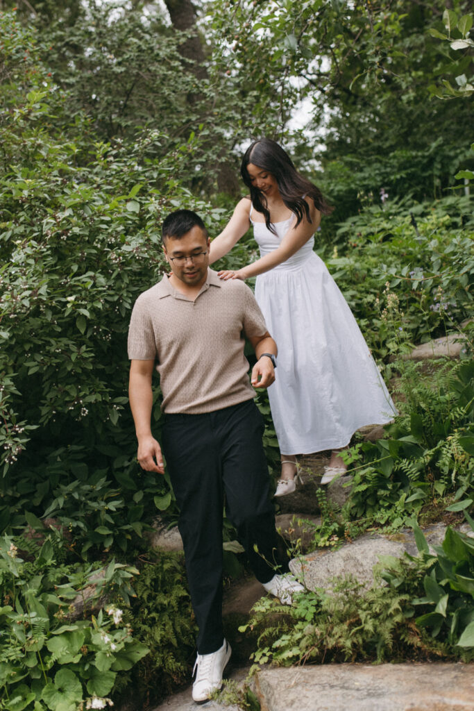 Couple walking down a winding path at Reader Rock Garden during their Calgary engagement session.