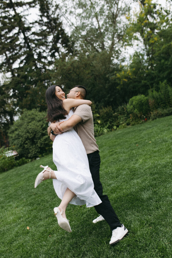 Movement shot of Lisa and Peter in the lush greenery of Reader Rock Garden during their Calgary engagement session.